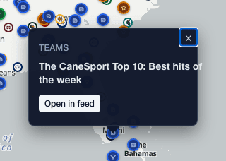 A story marker clicked open on the map, showing a dark popup with the headline and an Open in feed button.